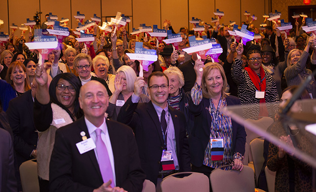 Texas REALTORS® at the 2020 Winter Meeting wave signs showing why they are proud members of the association.