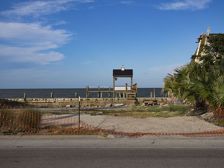 A pier sits behind an empty lot in the Key Allegro neighborhood in Rockport