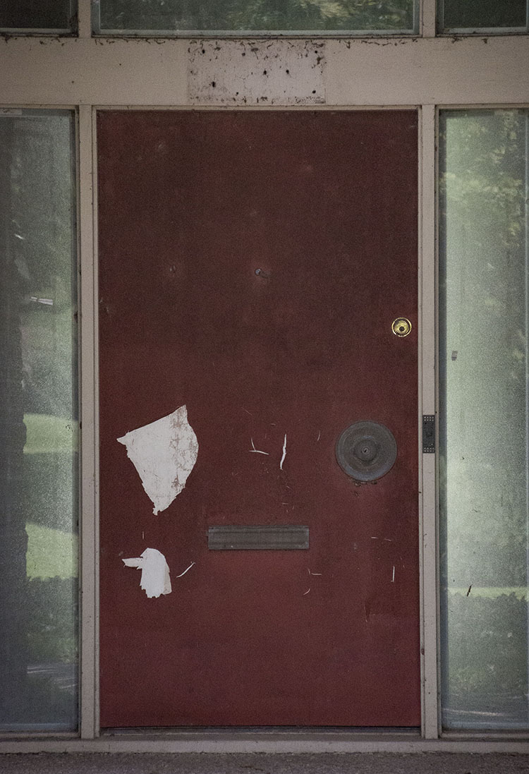 The front door of a Meyerland home is peeling and stained by high water