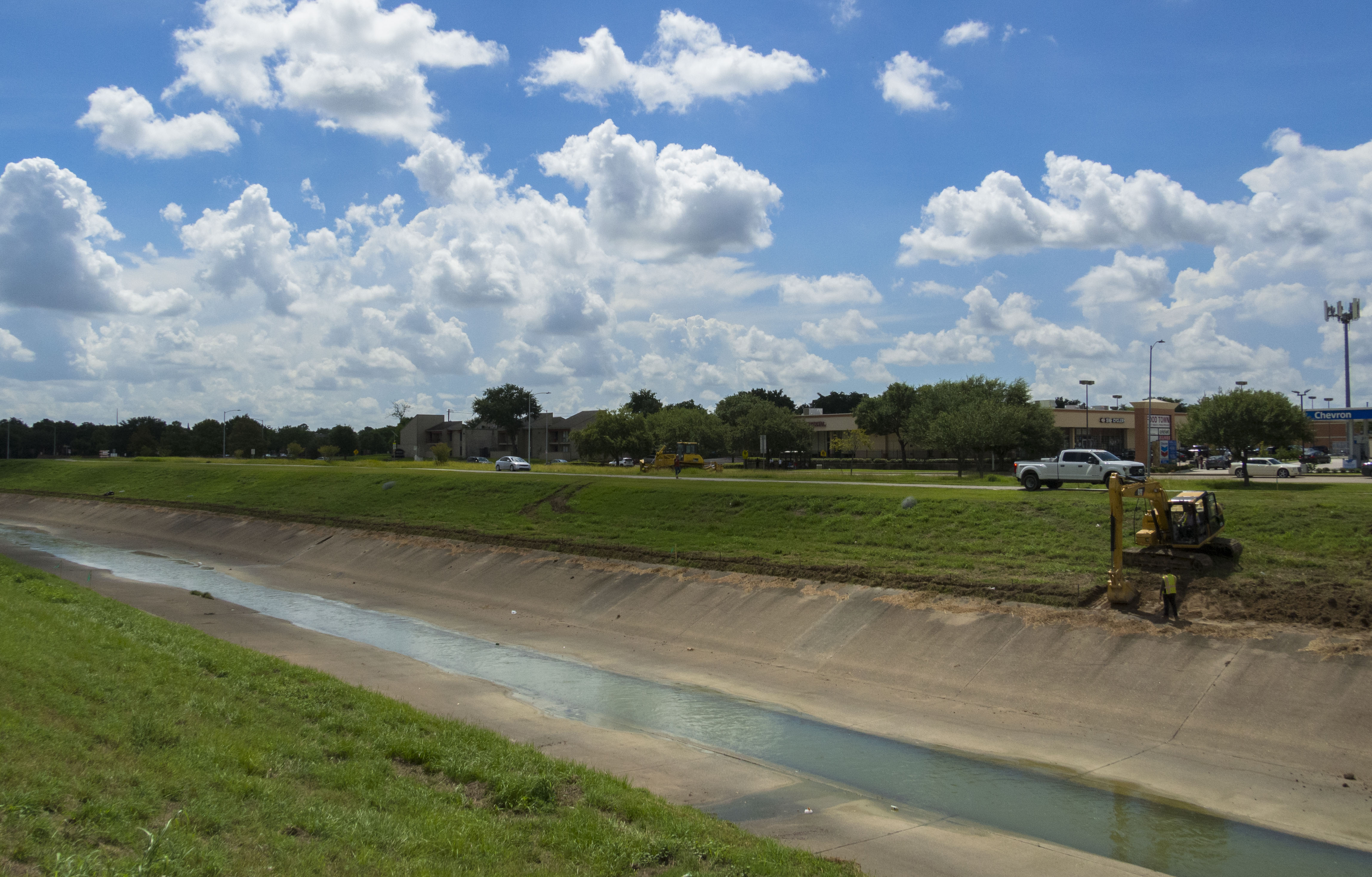 An excavator digs at the edge of Brays Bayou in Houston in August 2018.
