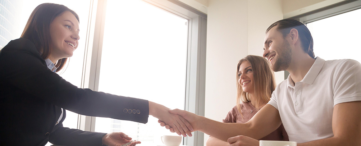 A Texas REALTOR shows professionalism in a meeting with clients