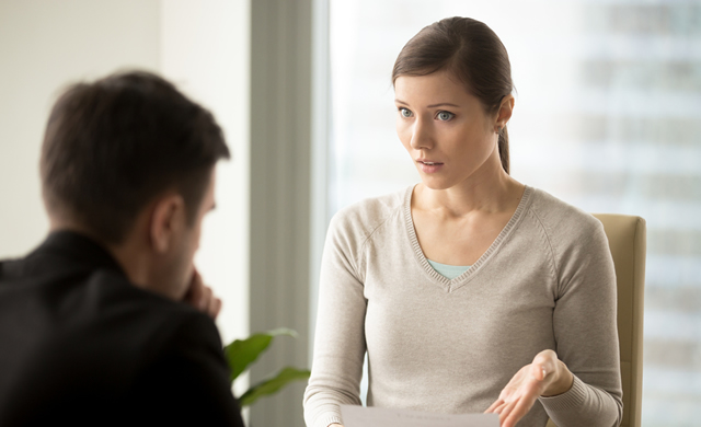 woman holding contract disagreeing with man