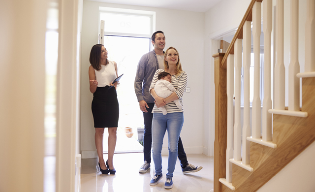 young family touring a home for sale with female agent