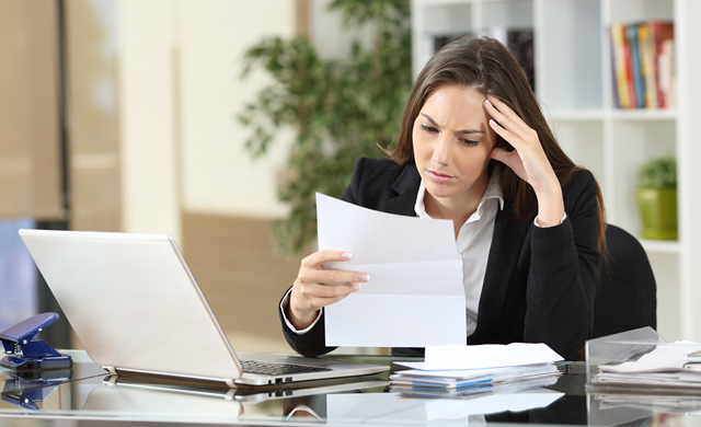 frustrated woman seated at desk