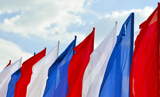 red, white, and blue flags on sky background